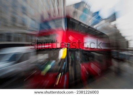 Energetic abstract zoom burst image of a classic red London bus in central London