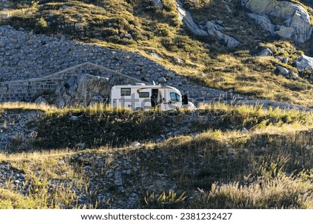 Scenic view of historic mountain pass road named Tremola with parked motor home at Swiss Gotthard Pass on a sunny late summer morning. Photo taken September 10th, 2023, Gotthard, Switzerland.