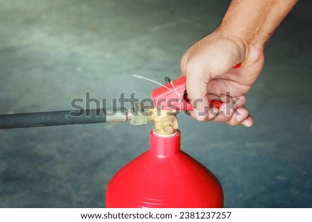 Male hands presses the trigger fire extinguisher, Closeup