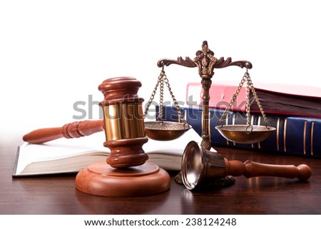 Gavel, bronze scales, bell and folders on the desktop judge