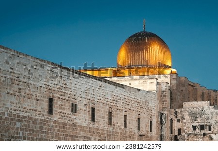 Al Aqsa Mosque on the Temple Mount in the Old Town of Jerusalem, Israel. View on the ancient mosque along southern wall of al-Haram al-Sharif, silver dome of Al-Aqsa in evening gold illumination. Royalty-Free Stock Photo #2381242579