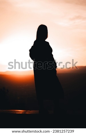 A shadow of a girl on a sunset sunrise view