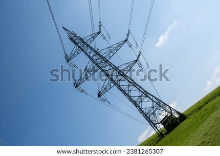 high voltage powerline blue sky Royalty-Free Stock Photo #2381265307