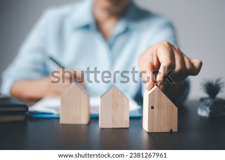 Wood house model coins money with account book finance and banking business finance concept for background. insurance or loan real estate.rent a house,get insurance or loan real estate or property.