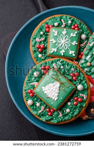Beautiful Christmas gingerbread cookies on a round ceramic plate on a textured concrete background