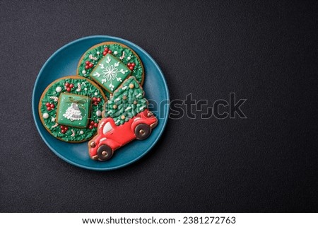 Beautiful Christmas gingerbread cookies on a round ceramic plate on a textured concrete background