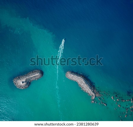 
Aerial View of A Boat Crossing Between Breakwaters Drone Shot Antalya Sea
