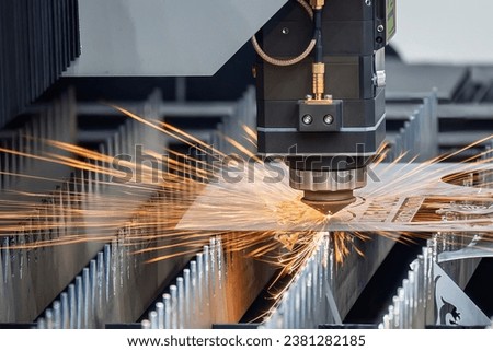 The fiber laser cutting machine  cut the metal plate with the sparkling light. The hi-technology sheet metal manufacturing process by laser cutting machine.  Royalty-Free Stock Photo #2381282185