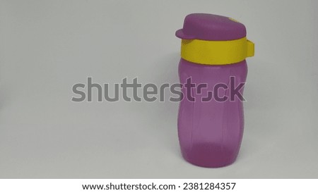 Purple mineral water bottle isolated on a white background
