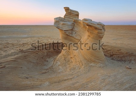Desert eroded rock pattern with clear sky during the sunset. Desert rock formation with erosion Royalty-Free Stock Photo #2381299785