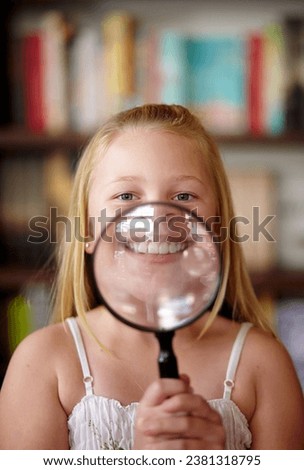 Portrait, library and child with a magnifying glass on her smile for education, inspection and studying. young, confident and a girl, kid or student with equipmwnt for a search or attention on mouth