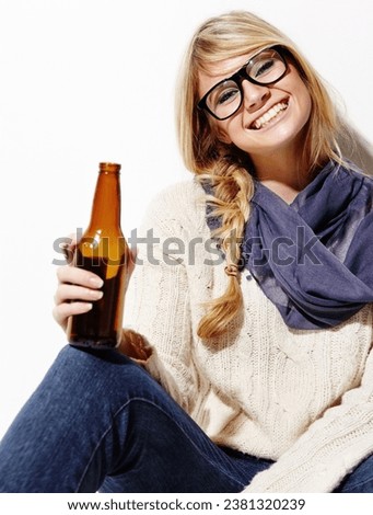 Happy woman, portrait smile and relax with beer of nerd, geek or hipster against a studio background. Attractive female person or model with glasses, nerdy or fashion style holding bottle of alcohol