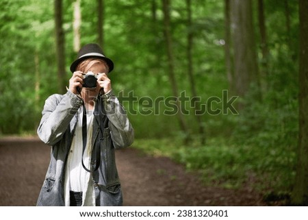 Photographer, nature and man with a camera, adventure and tourism with a view, journey and freedom. Person, photography and guy with mountains, traveller and retro with landscape, creative and trees