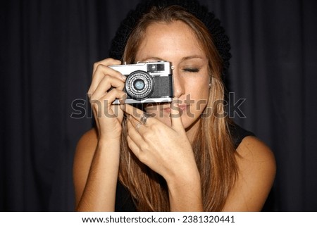 Woman, vintage camera and photographer in dark background, picture and hipster. Serious, youth and hobby with photography, perspective planning and eyes closed, creative and cool with mockup space