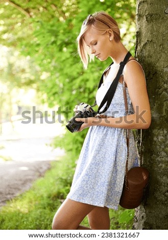 Memory, nature and photographer with woman in forest for relax, park and travel photography. Summer, trees and adventure with female person with camera for vacation, holiday and environmental tourism