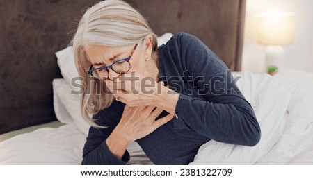 Illness, cough and senior woman in bed with allergies, flu or cold on a weekend morning at home. Sick, chest pain and elderly female person in retirement with asthma or infection in bedroom at house. Royalty-Free Stock Photo #2381322709