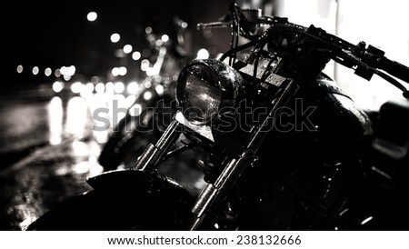 Motor bike headlight.Motorbike detail.Shiny chrome motorcycle.Closeup photo of motorcycle at night,active lifestyle,dangerous transport,journey and freedom concept.City traffic lights bokeh background