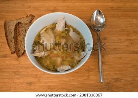 hot chicken soup with bread on the table