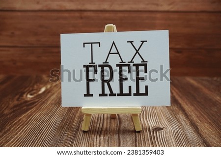 Tax Free text on paper card on wooden background