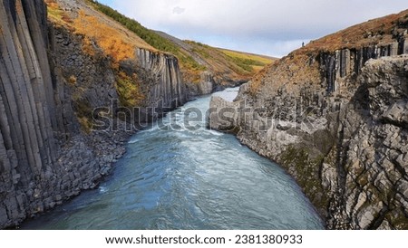 Aerial view of Stuðlagil Canyon in East Iceland, September 2023, beautiful basalt columns on either side, river flowing below