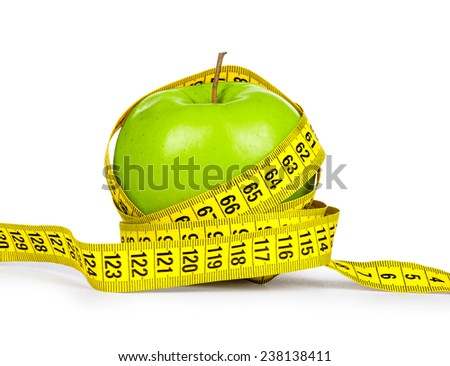 Diet concept. Green apple and yellow measuring tape on an isolated white background.