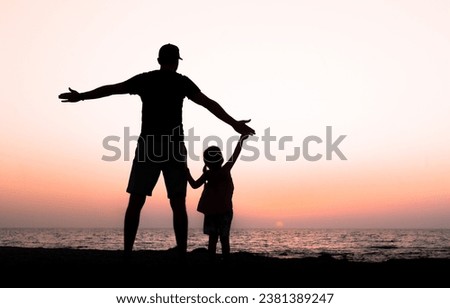 Father and daughter holding hands in sunset , romantic beach , picture full of love