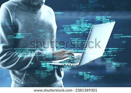 Close up of hacker using laptop with creative coding html language on blurry office interior background. Web developer, hacking, malware and programming concept. Double exposure
