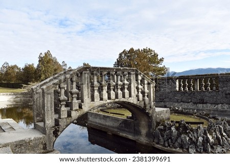 Slovenia, Karst, Štanjel, Ferrari's garden, bridge over pond Royalty-Free Stock Photo #2381399691