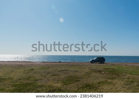 SUV on the coast of the peninsula in the ocean on a bright sunny day. natural light.