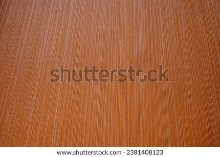 Orange background. The texture is decorative with a strip. Striped terracotta background.