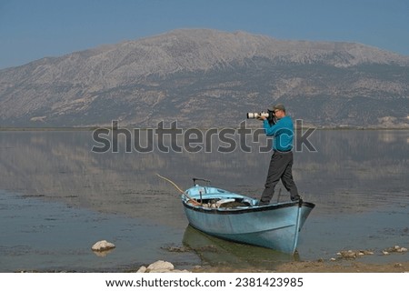 Photographer standing on the boat.