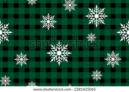 Snowflakes on a cute green checkered background. Seamless winter holiday pattern. Graphic scottish texture. Fashionable print for gift wrapping, fabric, cover, social media stories