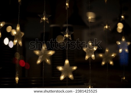 Star garlands. Decoration for new year. Garlands on Christmas tree. Lights in dark.