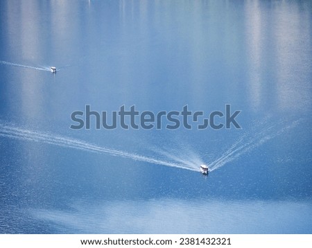 Tour boats high angle view crossing lake waters