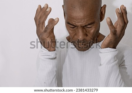 man praying to God with hands together on black background with people stock image stock photo