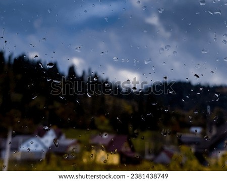 Drops of autumn rain on dirty window glass close-up