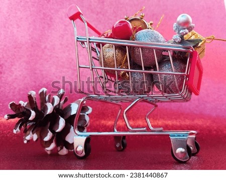 Shot of Christmas decorations on a market cart on a pink background