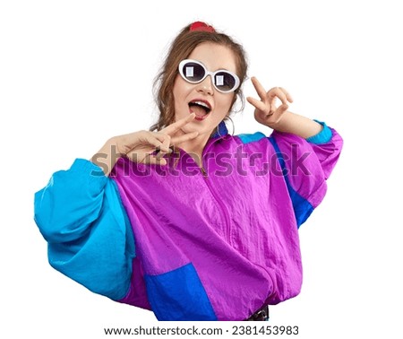 Cool teenager. Fashionable DJ girl in colorful trendy jacket and vintage retro sunglasses enjoys style of 80s-90s vibes. Teenager at disco party. Young fashion model isolated on white background.