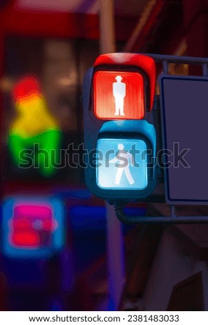Japanese traffic signal that changes color when pedestrians press a button. Translation, japanese traffic lights, Traffic signals in Japan in town push button.