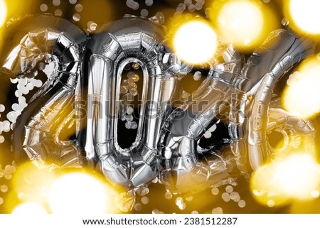 Holiday bokeh garland Happy new year 2026 metallic balloons with confetti on dark black background. Greeting card silver foil balloons numbers Christmas holiday concept. Celebration party
