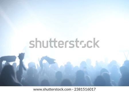 Over exposed photo of a crowd attending a live concert Royalty-Free Stock Photo #2381516017