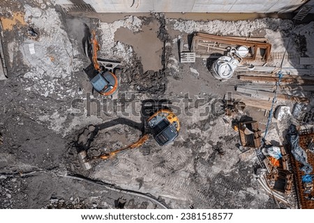 Aerial drone photo of demolition site and construction workers using heavy machinery
