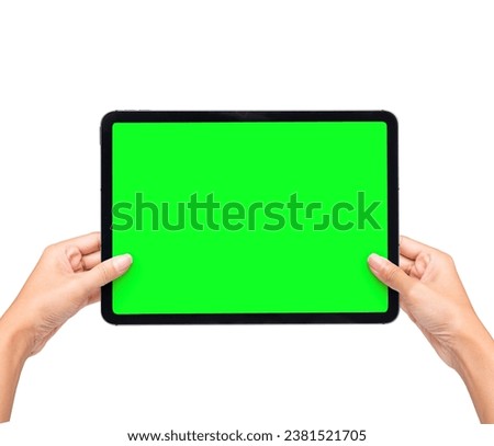 Hand Holding Black Tablet Pad Screen with black tablet computer, isolated on green screen background. Watching screen on Gadget presentation Mockup.
