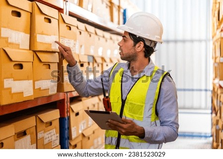 Portrait engineer man shipping order detail check goods and supplies on shelves with goods background inventory in factory warehouse.logistic industry and business export