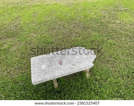 Photographs of a football field, a small practice field for a rural school, with a broken bench on the side of the field.