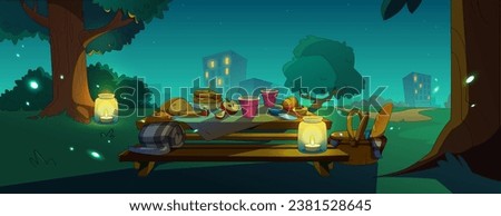 Night picnic in city park. Contemporary vector illustration of outdoor dinner on table in public garden with candles, meal basket, fresh fruit, cheese and bread, fireflies in air, cityscape view