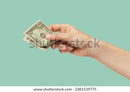woman hand holding one dollar isolated on green background	 Royalty-Free Stock Photo #2381539775