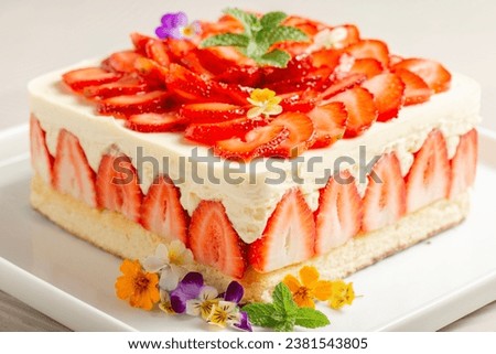 Delicious Fraisier Cake with a Genoese Sponge and Diplomat Cream, decorated with fresh strawberries and topped with Panna Cotta.  Royalty-Free Stock Photo #2381543805