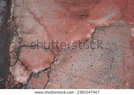 the cracked concrete floor of a house.