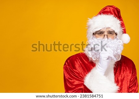 Santa Claus shows the gesture "hush", "shhh".